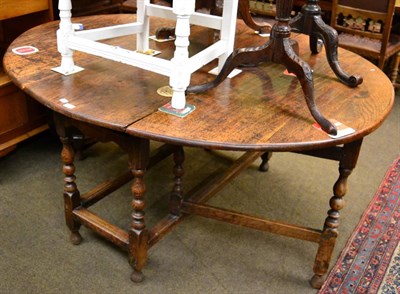 Lot 1369 - An 18th century oak gateleg table, oval form top, twin flaps, baluster turned legs and stretchers