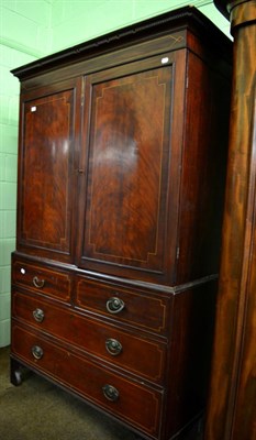 Lot 1388 - A 19th century inlaid mahogany linen press fitted with five dressing slides