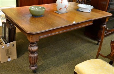 Lot 1399 - A late Victorian oak wind out dining table