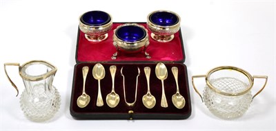 Lot 32 - ~ Silver mounted glass sugar and cream; cased silver spoons; George III silver salt; pair of...