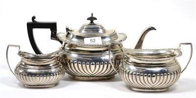 Lot 52 - A matched silver three piece tea service, Shefield 1906/07, part fluted with gadroon and shell rim