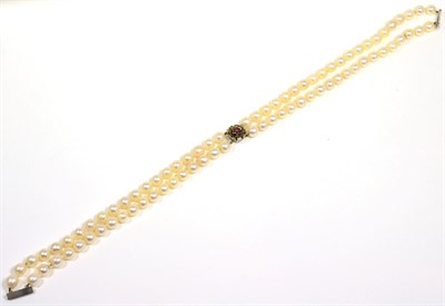 Lot 86 - A double strand cultured pearl necklace with a 9 carat white gold ruby cluster clasp, length 38cm