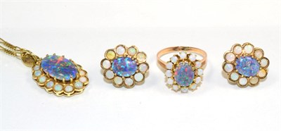 Lot 97 - An opal necklace, earring and ring suite; an oval opal triplet in a claw setting within a border of