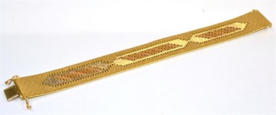 Lot 102 - A three colour bracelet, textured brick links with a pierced central motif, length 19.5cm,...