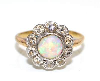 Lot 109 - An opal and diamond cluster ring, a round cabochon opal within a border of milgrain set old cut...