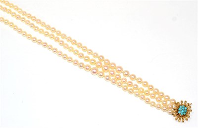 Lot 114 - A triple strand cultured pearl necklace, graduated pearls knotted to a turquoise set floral...