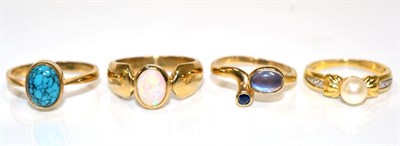Lot 115 - A 9 carat gold moonstone and sapphire torque ring, an oval cabochon moonstone and a round cut...