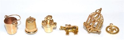 Lot 121 - Six various 9 carat gold charms, including; an Isle of Man charm, two champagne buckets, a bird...