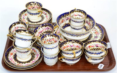 Lot 145 - ~ A 19th century floral painted cobalt blue, gilt highlighted part tea service (two trays)