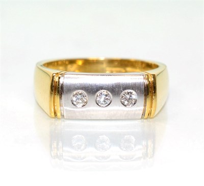 Lot 187 - An 18 carat gold three stone diamond ring, round brilliant cut diamonds inset to a brushed polished