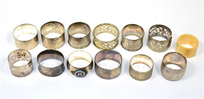 Lot 203 - Six various silver napkin rings; and a group of plated examples, three applied with enamel...