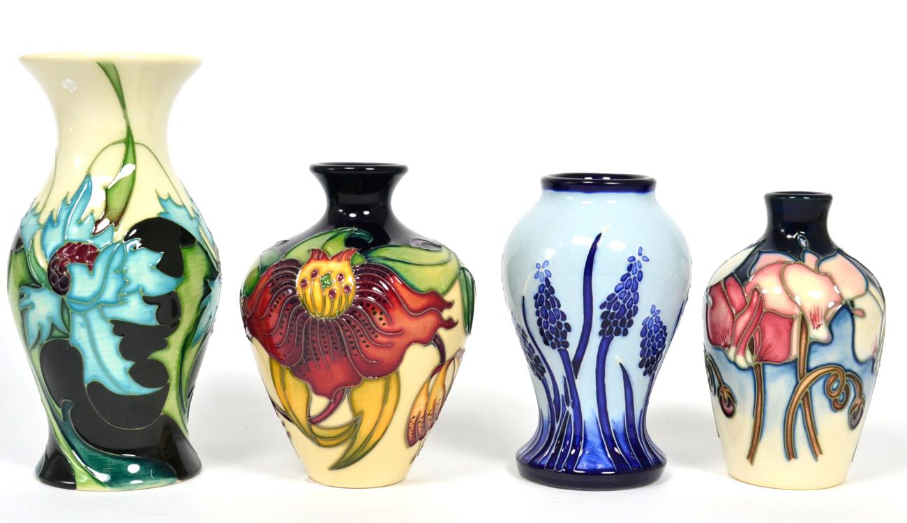 Lot 220 - Four Moorcroft miniature vases comprising Sea Holly (13cm), Anna Lily (10cm), Muscari Blue on...