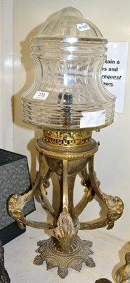 Lot 270 - ~ A gilt metal light fitting with rams head decoration and cut glass shade, 70cm high