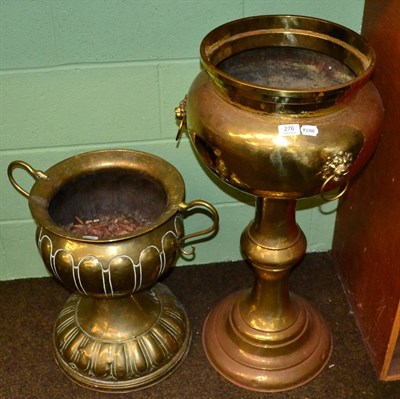 Lot 276 - ~ A brass pedestal jardiniere with three lion mask and ring handles; together with another...