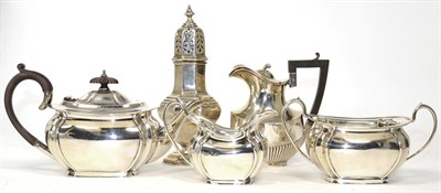 Lot 292 - ~ A silver three piece tea service, a silver caster and a hot milk jug