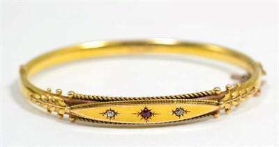 Lot 359 - A Victorian ruby and diamond bangle, a star set round cut ruby spaced by old cut diamonds, to a...