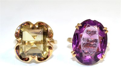 Lot 366 - A 9 carat gold smokey quartz ring, an octagonal cut smokey quartz in an extended double claw...