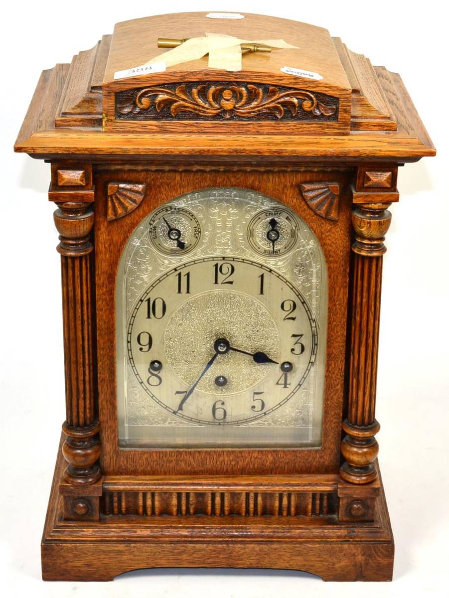 Lot 388 An oak chiming table clock, circa 1910