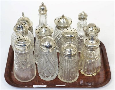 Lot 390 - Twelve silver topped glass casters