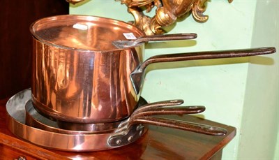 Lot 398 - A set of three copper pans; fire irons; and a copper pan and lid