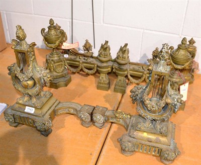 Lot 1143 - ~ Three pairs of French gilt metal andirons, one with an integral gilt metal fire curb (7)