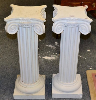 Lot 1195 - ~ A cast iron campana shaped urn, 46cm high; and pair of plaster columns, 75cm (3)