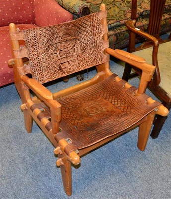 Lot 1208 - A South American armchair with tooled leather seat and back rest