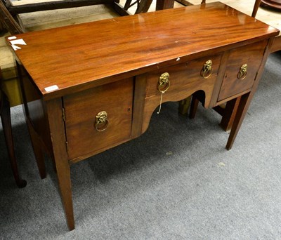 Lot 1246 - ~ A Regency small mahogany sideboard with lion mask handles