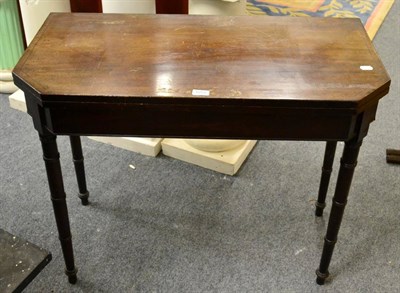 Lot 1251 - A mahogany folding tea table on turned legs