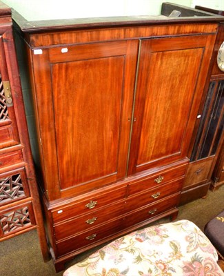 Lot 1303 - A George III mahogany linen press with sliding trays