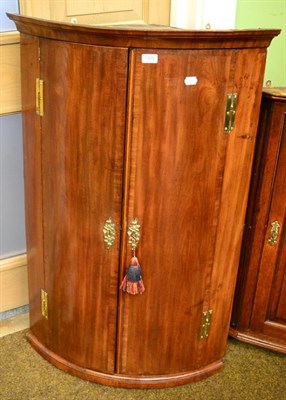 Lot 1305 - A crossbanded mahogany corner cupboard