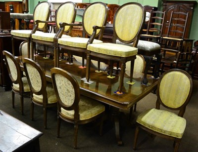 Lot 1319 - ~ A modern walnut twin pedestal dining table with three extra leaves and twelve chairs en-suite