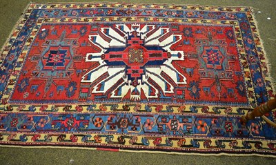 Lot 1355 - Karabagh rug, the madder field with 'eagle' medallion enclosed by indigo borders, 218cm by 148cm