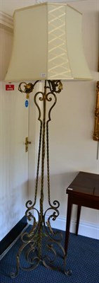 Lot 1371 - ~ A wrought iron tripod standard lamp