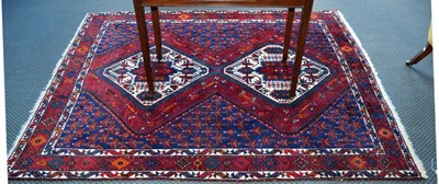 Lot 1387 - Afshar rug, the indigo field with twin medallions framed by diamond motif borders, 208cm by 170cm