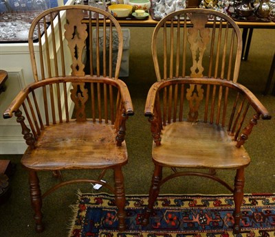 Lot 1391 - A pair of yew and elm Windsor chairs with crinoline stretchers