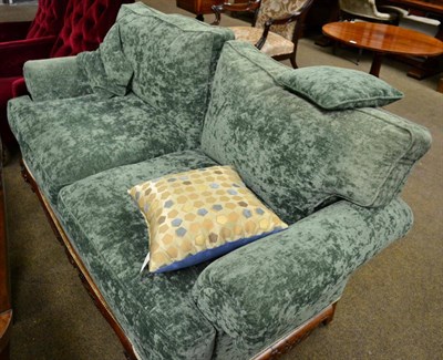 Lot 1399 - Two seater sofa with carved mahogany frame on ball and claw feet