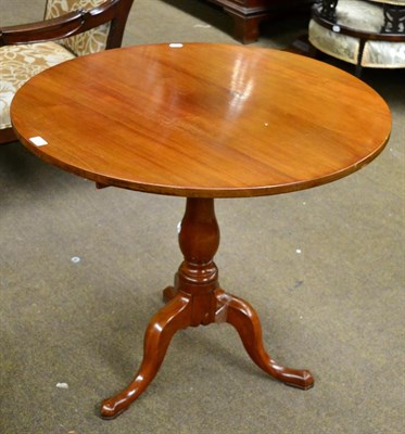 Lot 1403 - ~ A Georgian mahogany tripod table with baluster stem