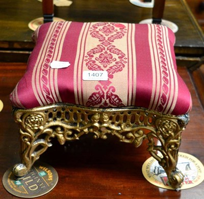 Lot 1407 - ~ A small upholstered gilt metal footstool