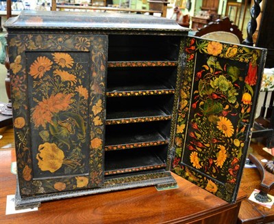 Lot 1416 - A floral decorated ebonised table cabinet