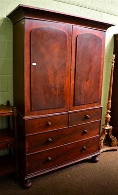 Lot 1445 - A Victorian mahogany linen press, with slide out trays, turned wood handles and on turned supports