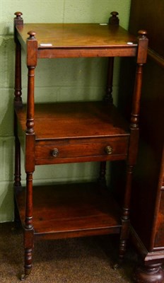 Lot 1446 - A 19th century mahogany three tier whatnot, the central shelf fitted with a drawer