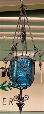 Lot 1468 - ~ A 20th century wrought iron and blue glass lantern