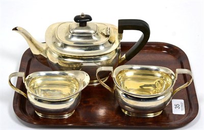 Lot 35 - A silver three piece teaset, by H.A. Sheffield, 26.26ozt (3)
