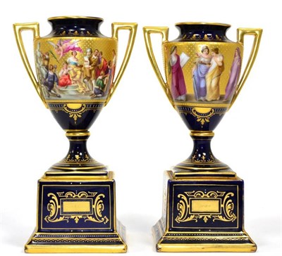Lot 51 - A pair of Vienna porcelain painted and gilt urns on plinth bases decorated with classical figures