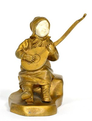 Lot 55 - An early 20th century gilt bronze and ivory figure of a musician