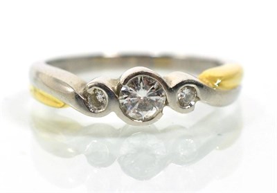 Lot 81 - A platinum diamond three stone ring, graduated round brilliant cut diamonds in half rubbed over...