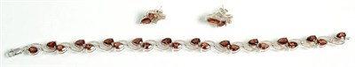 Lot 105 - A garnet bracelet, pear cut garnets to textured scroll links, length 19.5cm, together with a...