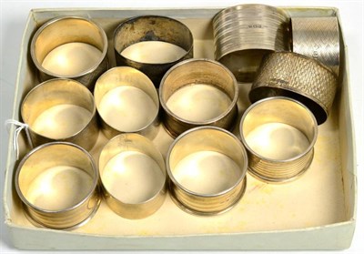 Lot 117 - Five pairs of silver napkin rings; together with two further examples, various dates and...