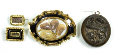 Lot 136 - A mourning brooch, a central panel containing hairwork, to a black enamel border within a fancy...